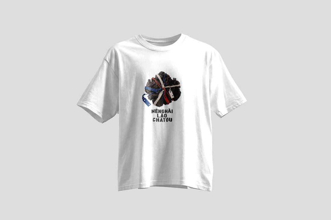 A dense pu'er clump wrapped in indigo and off-white canvas webbing with red and blue cords and blank punched plastic tags